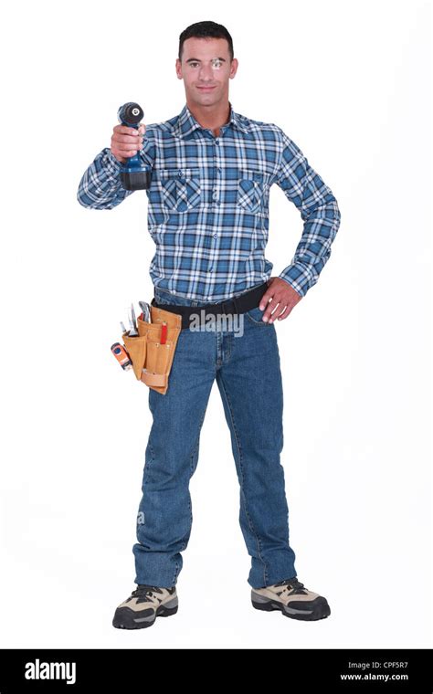 Tradesman aiming his power tool Stock Photo - Alamy