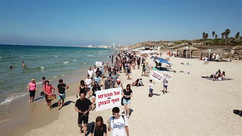 Surfers protest plans for breakwater off last open beach in Tel Aviv ...