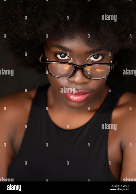 Beautiful young black woman with afro hair, wearing glasses Stock Photo ...