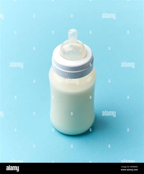 baby milk bottle on blue background Stock Photo - Alamy