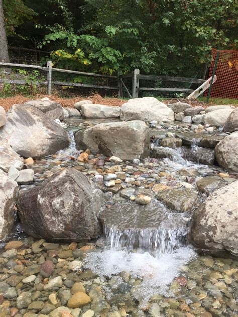 Close up of the Natural Stone Waterfall and Diving board into Swimming ...