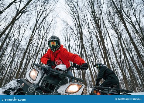 On the Off Road. Two People are Riding ATV in the Winter Forest Stock ...