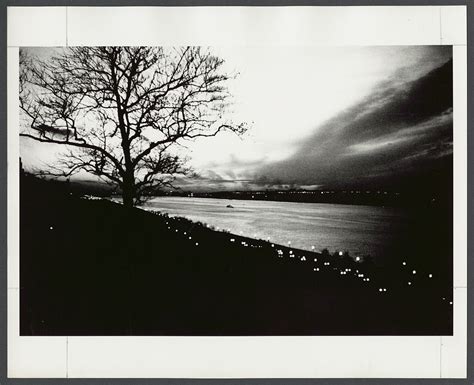 [View of river at night, waterfront with street lamps visible in ...