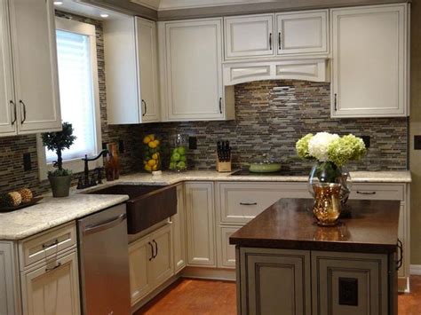 a kitchen filled with lots of white cabinets and counter top space next ...