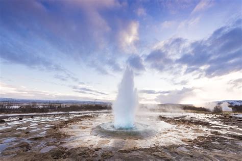 Eruption of Strokkur geyser in Iceland. Winter cold colors, sun ...