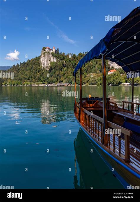 A picture of one of Lake Bled's gondolas, named "pletna", overlooking ...