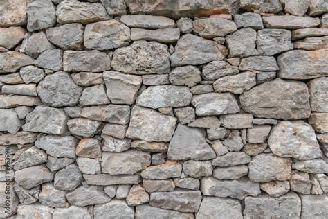 Stone wall texture background - grey stone siding with different sized ...