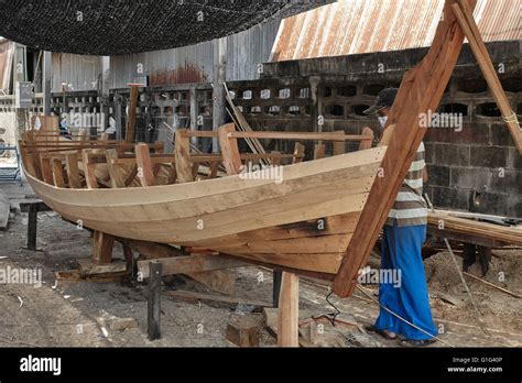 Thailand boat builder. Craftsman building a traditional wooden boat ...