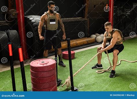 Sled Drag Exercise. Sportsman during His Cross Training Workout. Stock ...