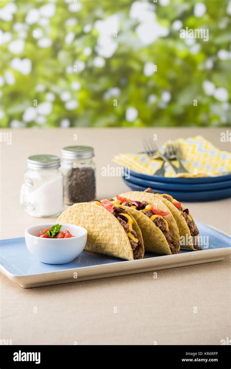 Mexican tacos with beef, cheddar cheese, tomato Stock Photo - Alamy