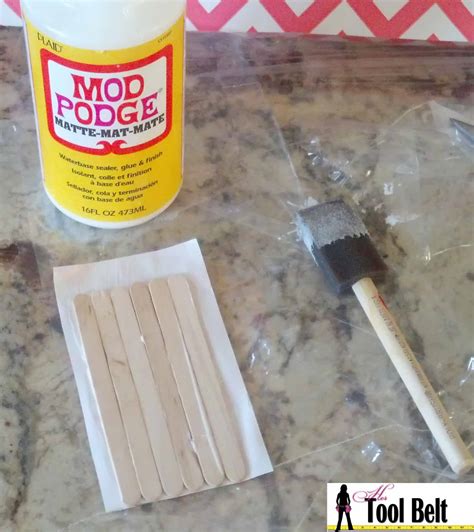 mod podge paper onto sticks - Her Tool Belt