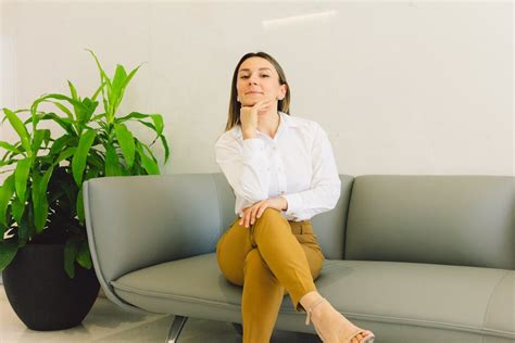 A Woman Sitting on a Sofa · Free Stock Photo