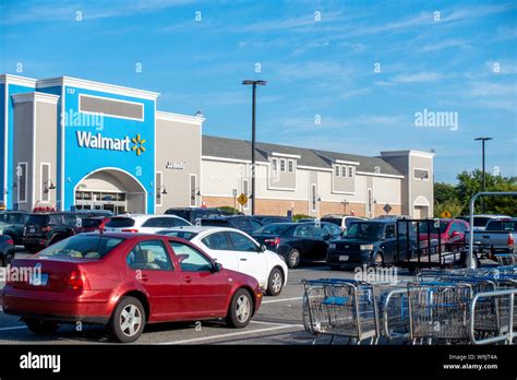 Walmart store exterior with cars in parking lot and shopping carriages ...