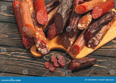 Different Types of Sausages and Meat Products on a Wooden Board Stock ...