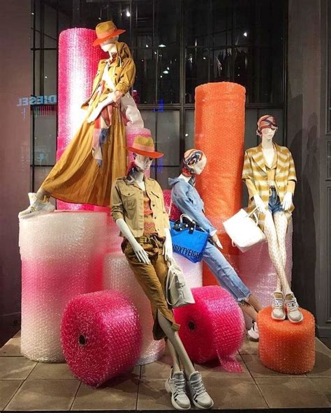 Beautiful female mannequins in a gorgeous colorful window display ...