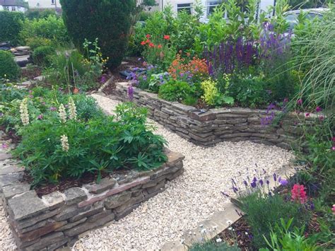 Raised stone flower beds with gravel path | Raised garden, Garden ...