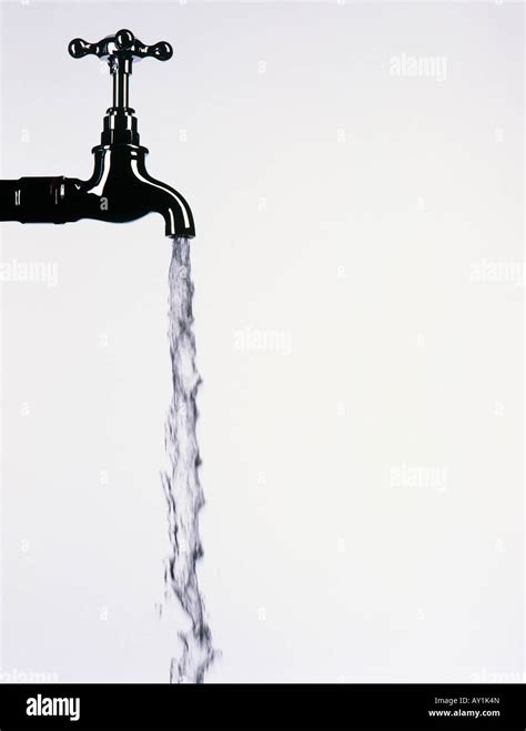 Tap with water flowing from it Stock Photo - Alamy