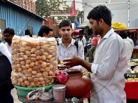 Image of Indian Street Food Panipuri Or Golgappae Vendor Serving At a ...