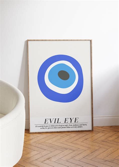 an evil eye poster on the wall next to a white chair