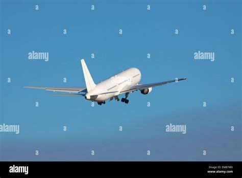 White airplane is taking off to the blue sky Stock Photo - Alamy