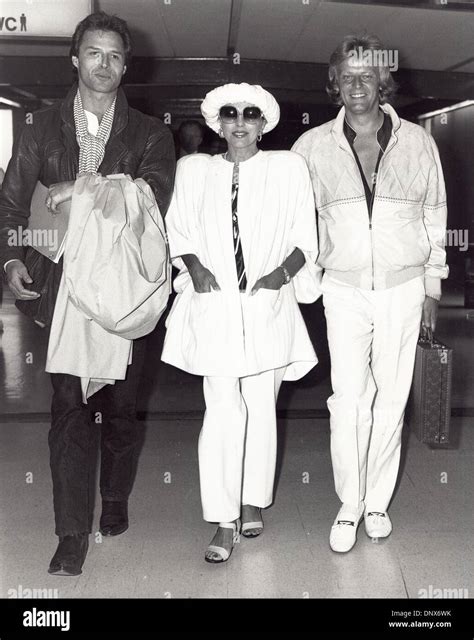 Sept. 19, 1985 - JOAN COLLINS with her fiance Peter Holm and Michael ...