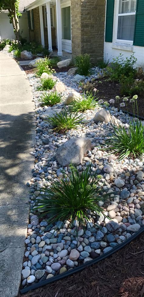 Mixing stone with plants to create a low maintenance foundation ...