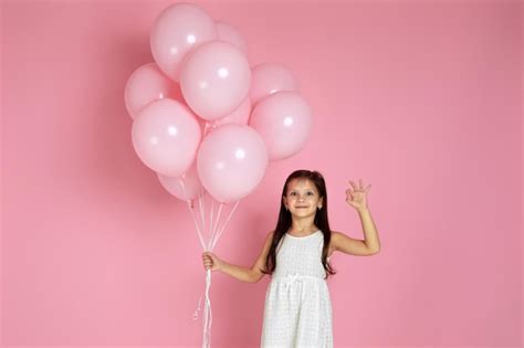 Premium Photo | Smiling adorable little child girl with pastel pink air ...