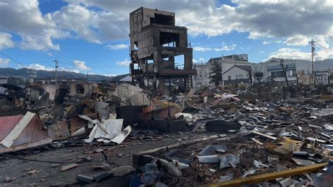 Japan earthquake: Trapped woman pulled to safety from rubble after ...