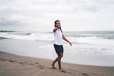 Cheerful Black Man Walking on Beach Stock Photo - Image of trip, male ...