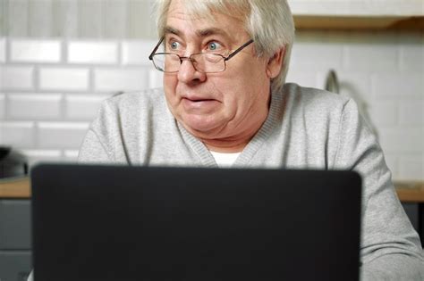 Premium Photo | Senior grey haired man wearing glasses sitting at ...