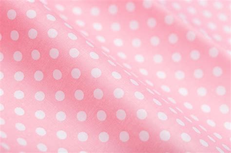 Premium Photo | Pink cotton fabric with white polka dots