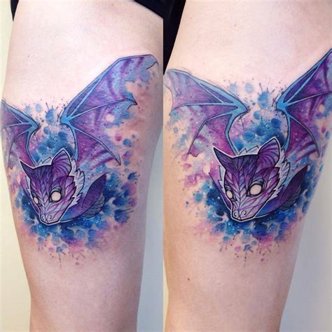 Watercolor style bat tattoo on the right thigh.