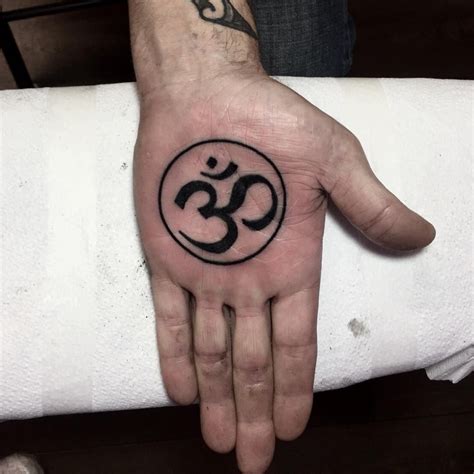 Black Om symbol tattoo on the left palm | Circle tattoo, Tattoos, Om ...