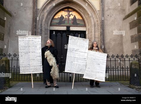 Two people proselytize as a part of Reformation Day celebrations in ...