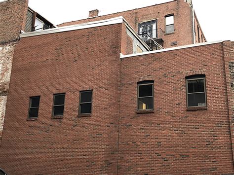 Abbot rebuilds brick wall on a 4-story building at 35 Wareham St. : NEREJ