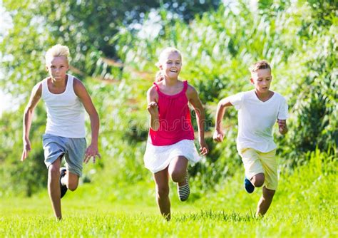 Kids playing active games stock image. Image of green - 205269801