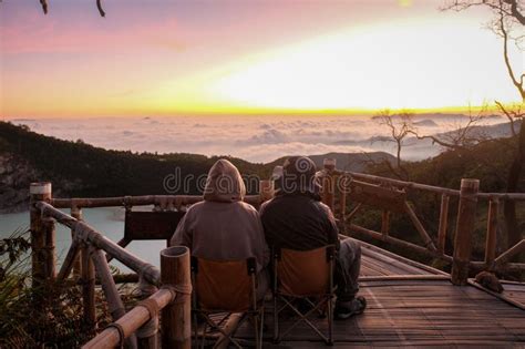 Campers Admire Sunrise at Kawah Putih, Seated on Wooden Ledge Stock ...