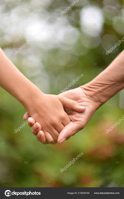 Two People Holding Hands Nature Stock Photo by ©aletia 219249150