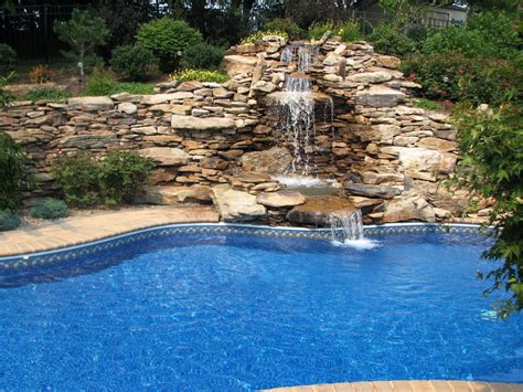 Pool with natural stone waterfall return | Landscape projects, Pool ...