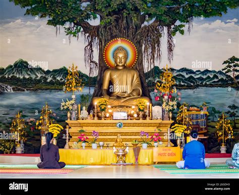 Prayer inside a Buddhist temple in Vietnam, Buddha statue worship in an ...