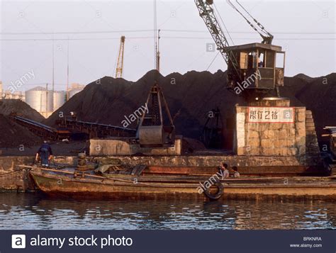 A coal barge awaits loading at an urban dock Stock Photo - Alamy