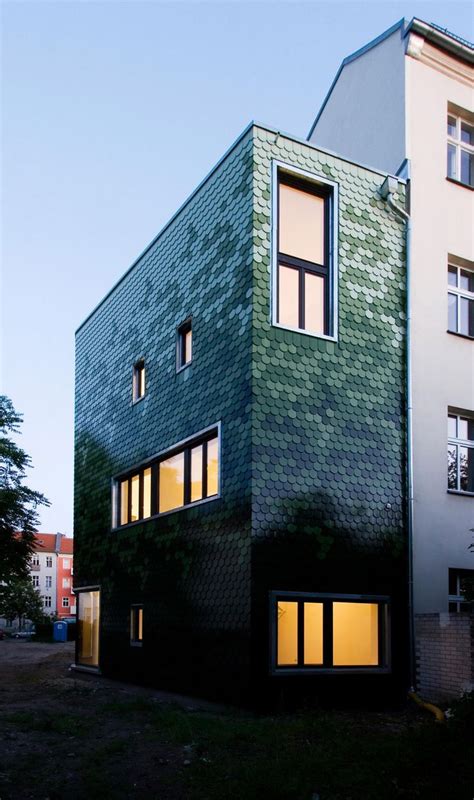 Green shingles cover Brandt + Simon Architekten's Schuppen house ...