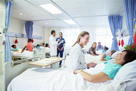 Doctors, nurses and patients in hospital room - Stock Photo - Dissolve