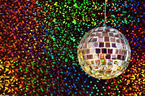 Disco glitter ball. A silver mirrored disco glitter ball against a ...