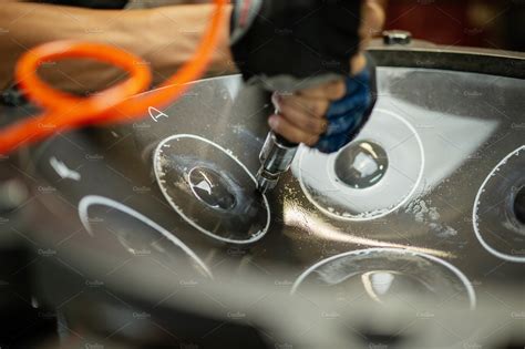 Artisan constructing handpan with ha stock photo containing air hammer ...