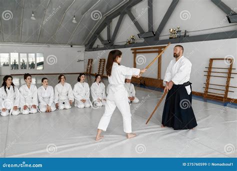 Girl and Aikido Master Fighting with Wooden Sword during Martial Arts ...