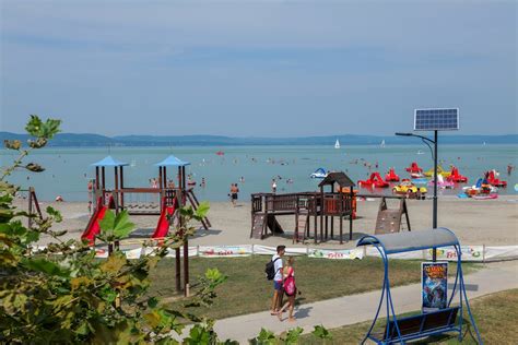 A beach with children's play equipment and a solar panel · Free Stock Photo