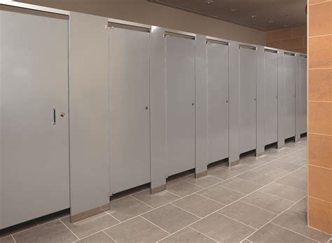 a row of stalls in a public restroom with tile flooring and walls lined ...