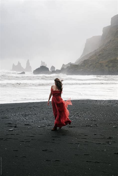 "Yang Women In A Red Long Dress Walks On The Black Sand Beach, VIk ...