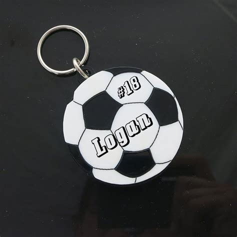 a black and white soccer ball keychain with the words liquid written on it